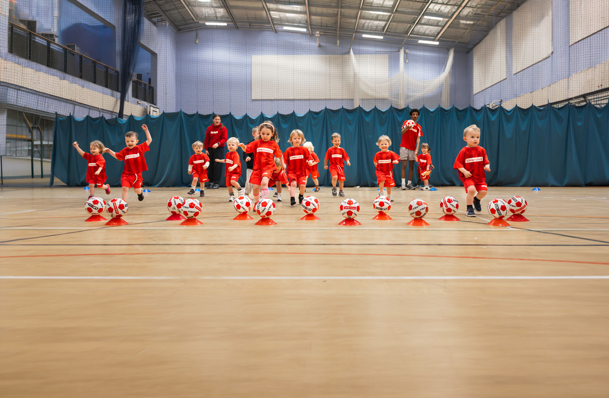 Little Kickers players running to balls